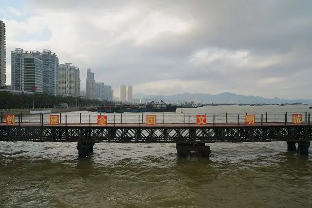 Xiangzhou harbour in Zhuhai on background. on foreground, a temporary metal bridge built for trucks aiming to build the futur Zhuhai Opera on Yeli Island.